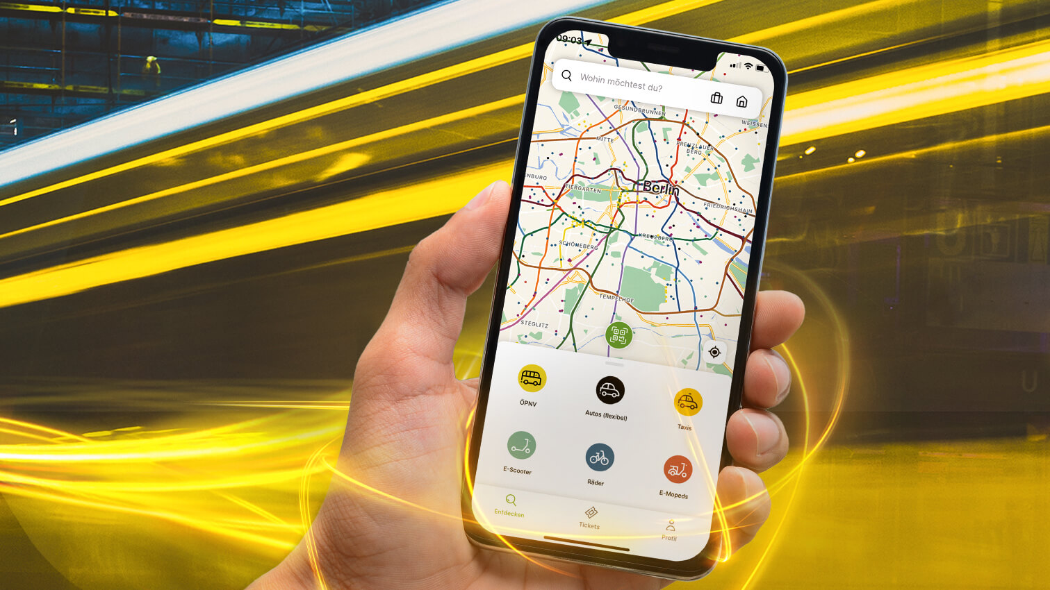 Bild zeigt die Nutzung der Jelbi-App via Handy sowie eine Tram im Hintergrund, die vorbeirauscht